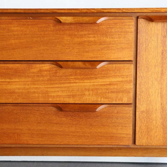 Vintage teak sideboard by Austinsuite featuring smooth grain, mid-century British design, and sculpted drawer handles.