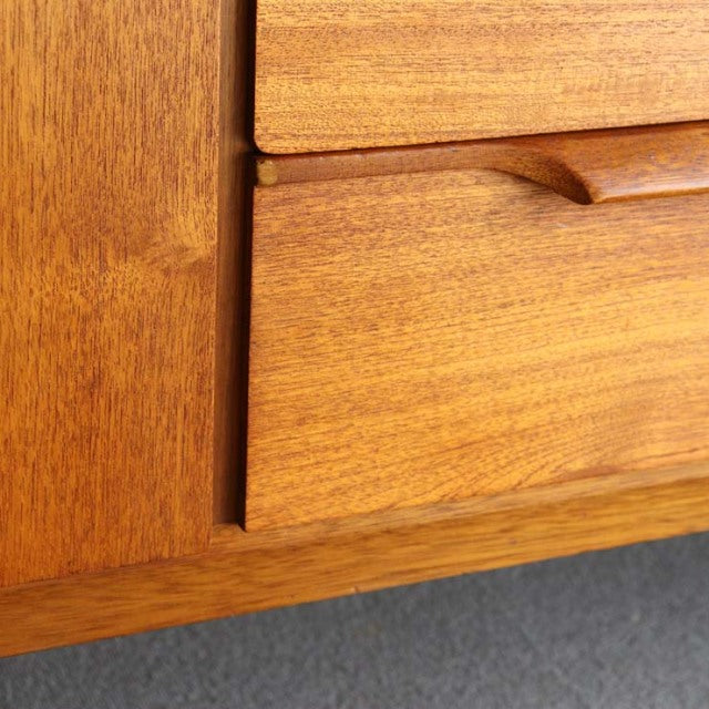 Close-up of vintage AustinSuite teak sideboard drawer with rich wood grain and mid-century British-Denmark design detail.