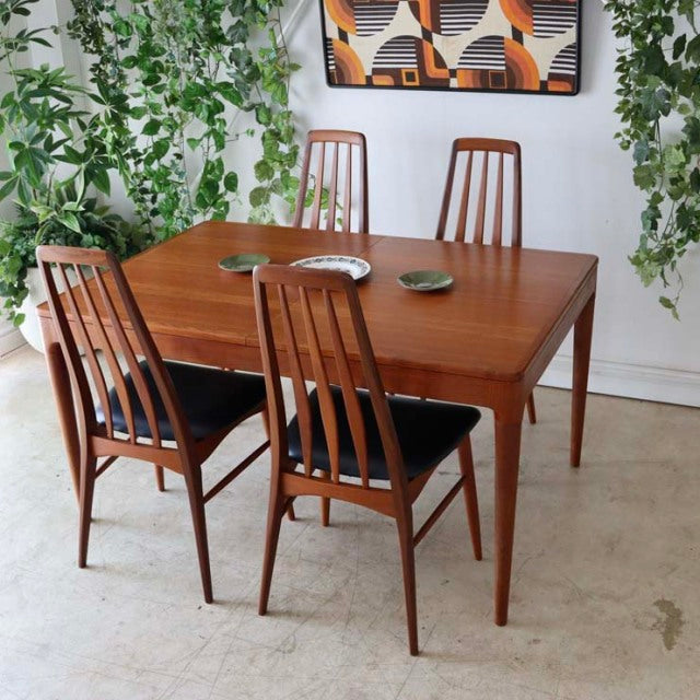 Vintage mid-century teak dining table from Denmark with rectangular top and tapered legs, paired with four matching wooden.