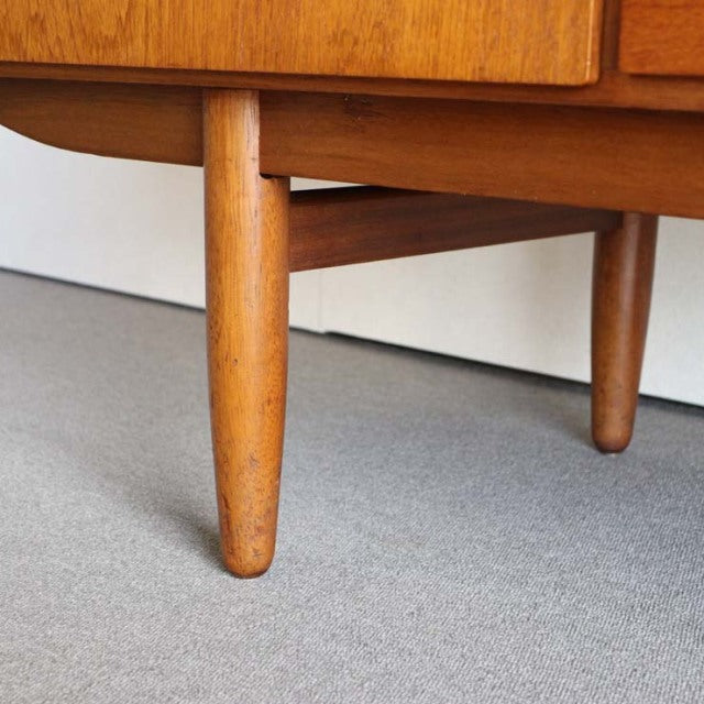Mid-century vintage teak sideboard leg from British Denmark-inspired Austinsuite with smooth wood grain and rounded tapered.
