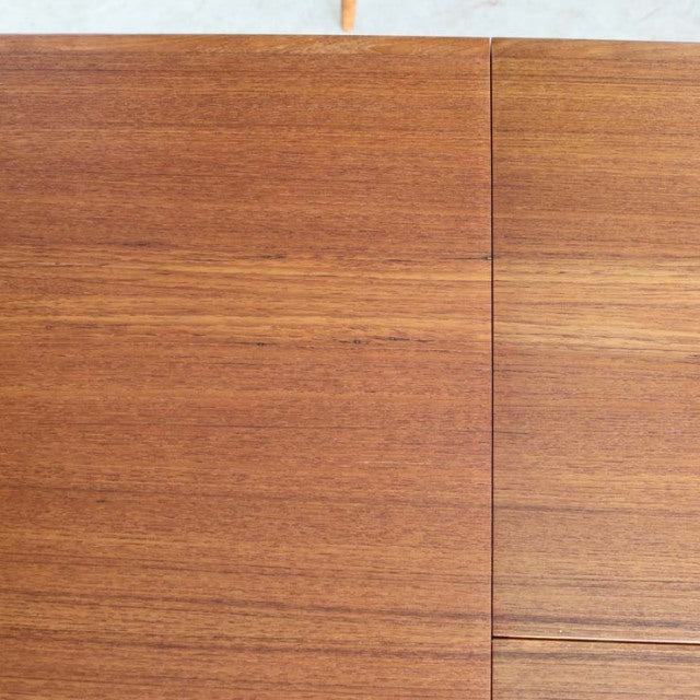 Mid-century vintage Danish teak dining table top showing warm wood grain and clean rectangular lines.