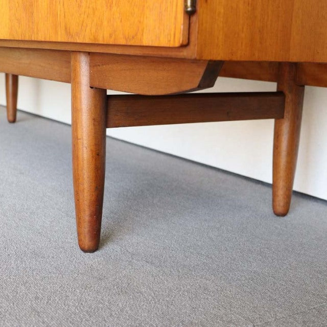 Mid-century British vintage teak sideboard leg with smooth wood grain and sturdy crossbar support.