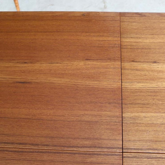Mid-century vintage teak dining table from Denmark with rich wood grain and clean lines.