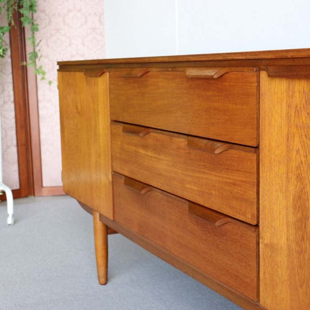 Vintage mid-century Austinsuite teak sideboard with rich wood grain, tapered legs, and sleek British-Denmark design.