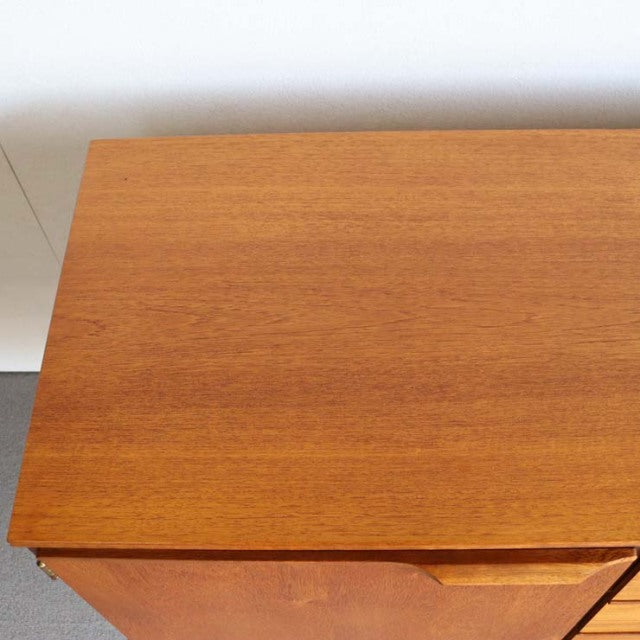 Vintage teak sideboard by Austinsuite featuring smooth wood grain top, clean mid-century British design, and tapered legs.