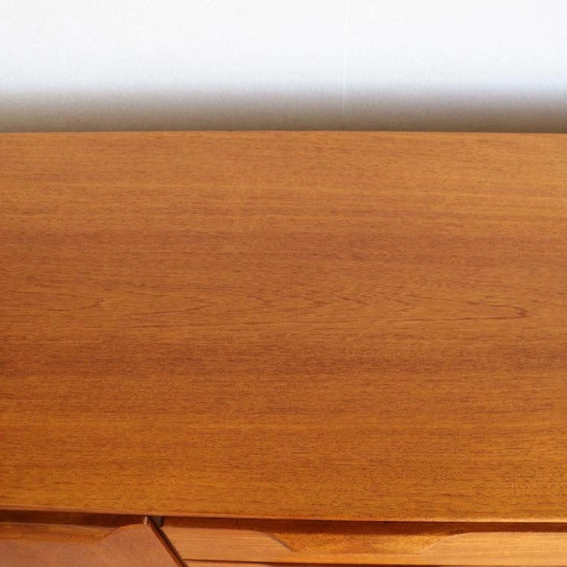 Vintage Austinsuite teak sideboard top showing smooth wood grain with warm mid-century British and Danish design.