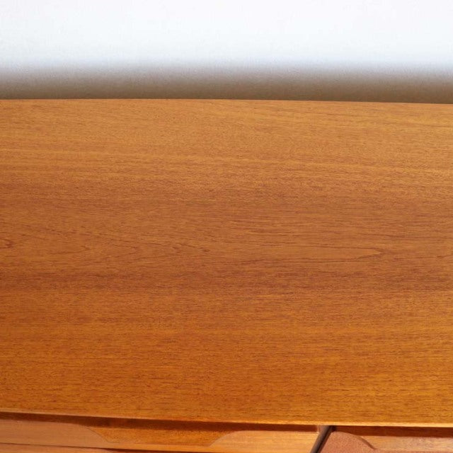 Vintage teak AustinSuite sideboard top surface showcasing rich wood grain with smooth mid-century British design.