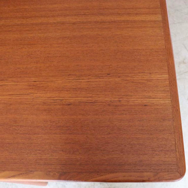 Vintage teak dining table top with fine wood grain and smooth rounded edges, mid-century Danish design.