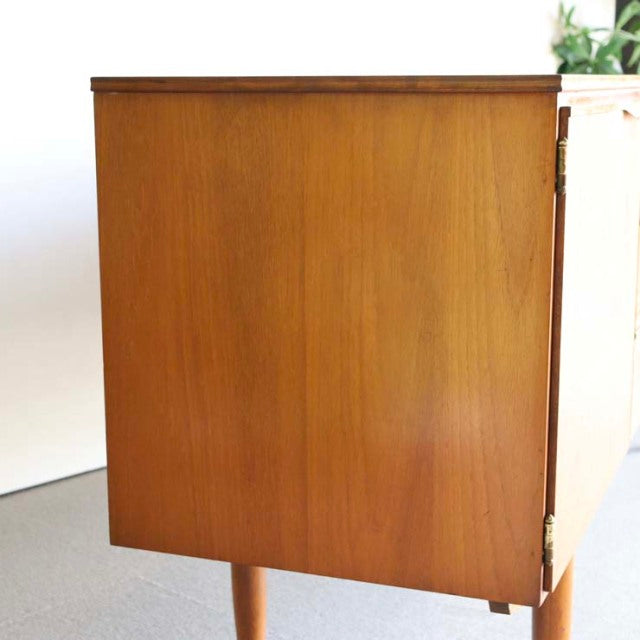 Vintage teak sideboard by Austinsuite with smooth wood grain, mid-century British design, slender legs, and clean lines.