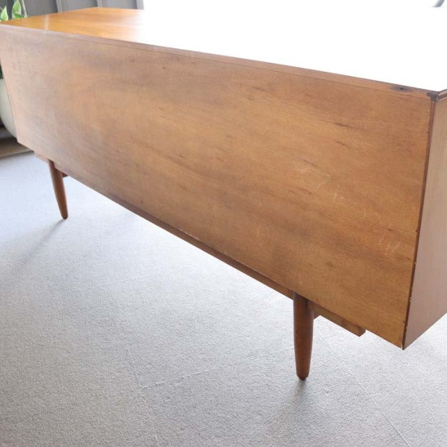 Vintage teak sideboard by Austinsuite with smooth wood grain and tapered mid-century British legs.