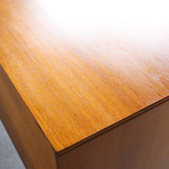 Vintage British mid-century Austinsuite teak sideboard corner showing smooth wood grain and warm honey tones.