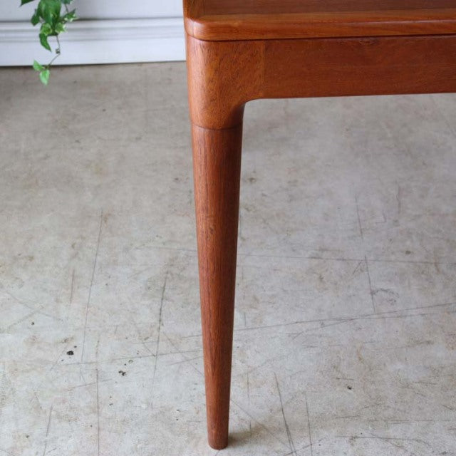 Mid-century vintage teak dining table leg with rounded edges and smooth wood grain from Denmark.