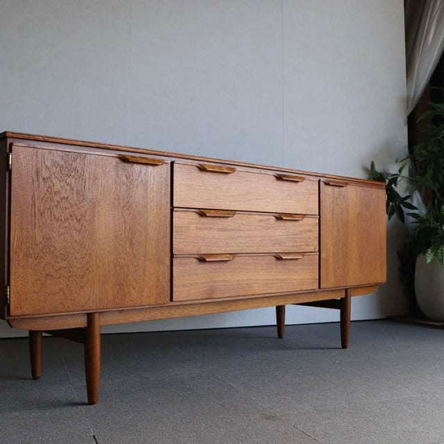 Vintage teak sideboard by Austinsuite featuring clean mid-century British design with tapered legs and warm wood grain.
