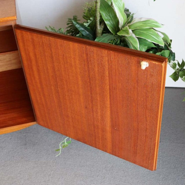 Vintage mid-century British teak sideboard door with rich wood grain and angled top edge.