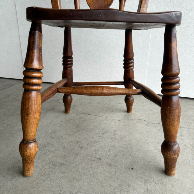 Vintage British teak kitchen chair with turned legs and horizontal stretchers, mid-century Denmark style wood grain visible.