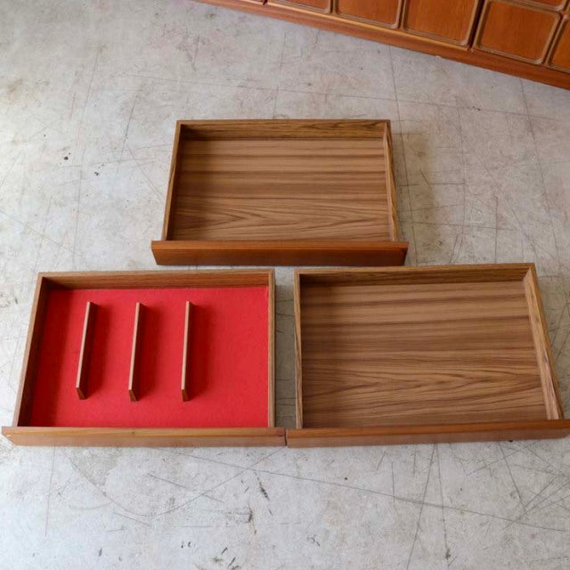 Mid-century British McIntosh sideboard drawers in vintage teak with rich wood grain and red felt dividers.