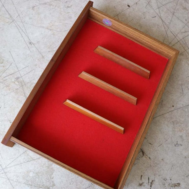 Vintage teak drawer interior with red felt lining and three wooden dividers from British mid-century McIntosh sideboard.
