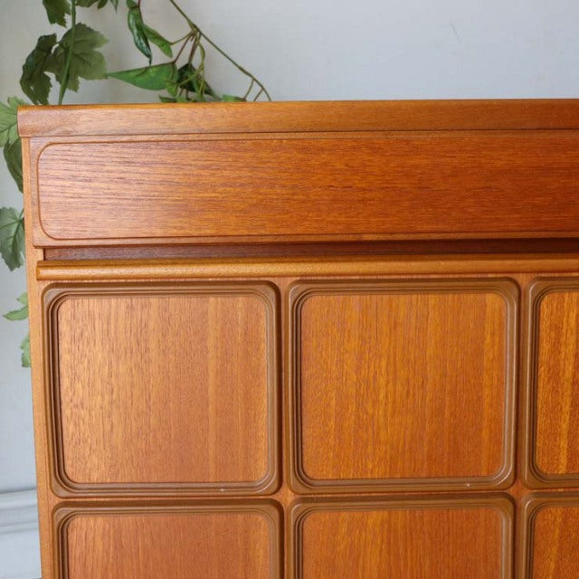 Vintage McIntosh teak sideboard with British mid-century Denmark design, featuring wood grain panels and sleek legs.