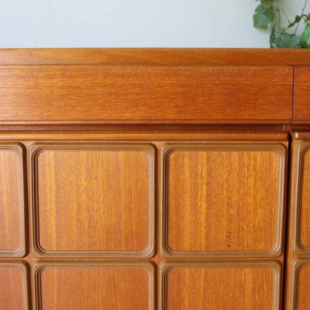 Vintage McIntosh teak sideboard front panel with rich wood grain and rounded square detailing, mid-century British-Denmark.