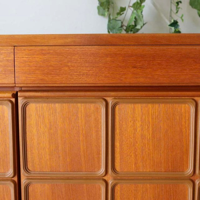 Vintage McIntosh mid-century teak sideboard with recessed panel doors and rich wood grain detailing.