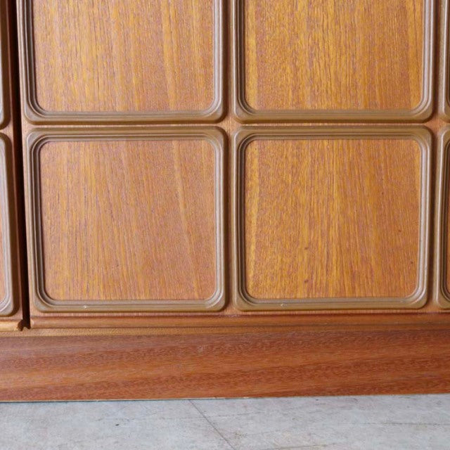 Close-up of vintage teak wood grain and smooth square panel details on mid-century British McIntosh sideboard from Denmark.