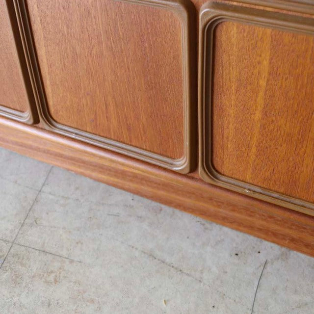 Vintage teak McIntosh sideboard with rich wood grain, rounded edges, and sleek mid-century British design from Denmark.