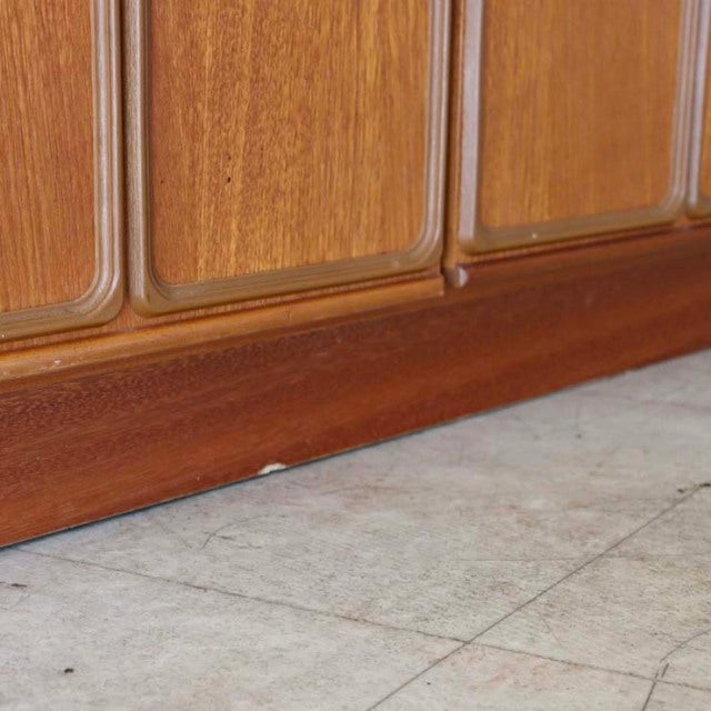 Vintage McIntosh teak sideboard base with smooth grain and rounded panel edges, mid-century British design from Denmark.