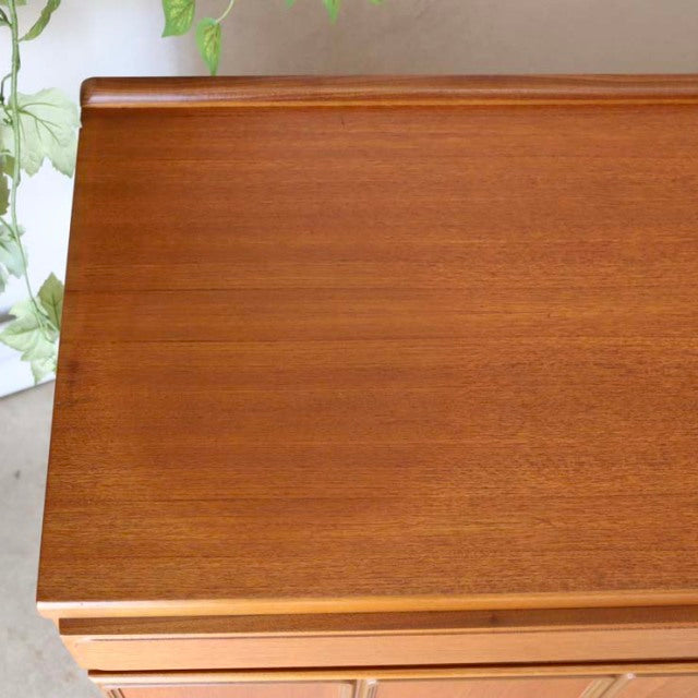 Vintage mid-century British teak sideboard with smooth wood grain and clean rectangular top from McIntosh Denmark design.