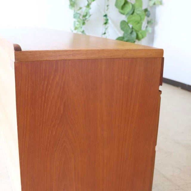 Vintage teak McIntosh sideboard with smooth wood grain, clean mid-century lines, and British-Denmark design influence.