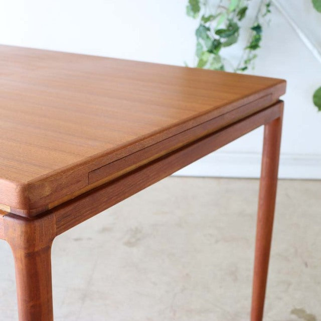 Mid-century vintage teak dining table by Johannes Andersen with smooth wood grain and rounded square legs in British-Denmark .