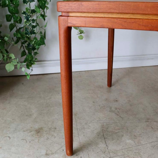 Mid-century vintage teak dining table leg with smooth wood grain and tapered British Denmark design.