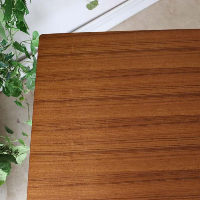 Mid-century vintage teak dining table by Johannes Andersen with rich wood grain and clean rectangular top, British Denmark.