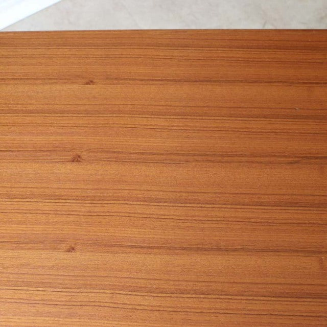 Vintage teak dining table top with smooth wood grain, mid-century Denmark design, British influence.