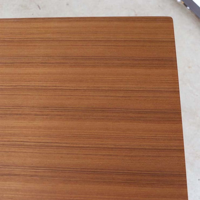 Vintage teak dining table top showing fine wood grain and smooth mid-century British design by Johannes Andersen, Denmark.