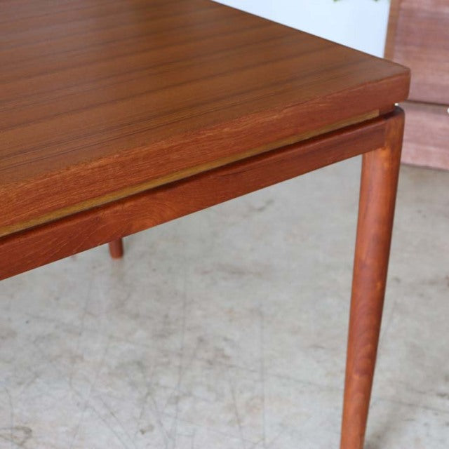 Mid-century vintage teak dining table by Johannes Andersen with smooth wood grain and tapered legs in Danish-British style.