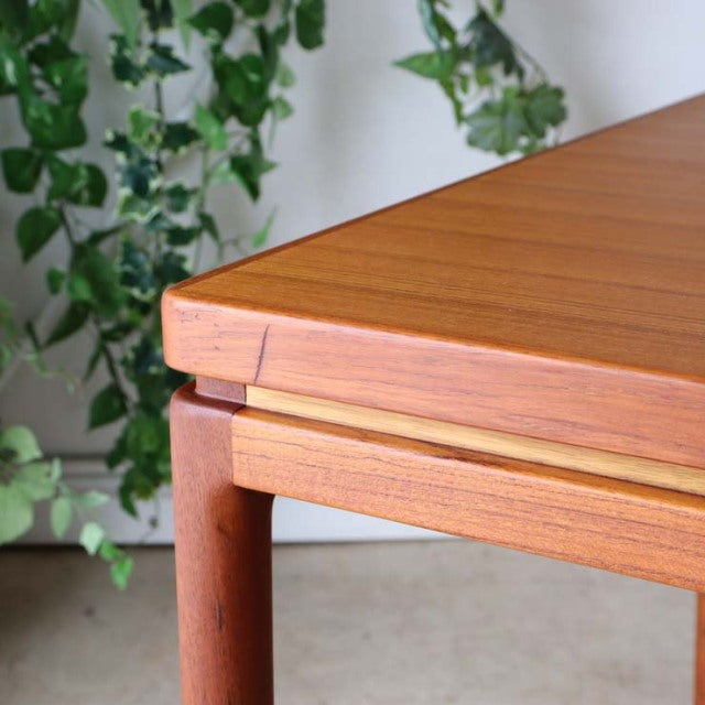 Mid-century vintage teak dining table by Johannes Andersen, Danish design with clean lines and visible wood grain.