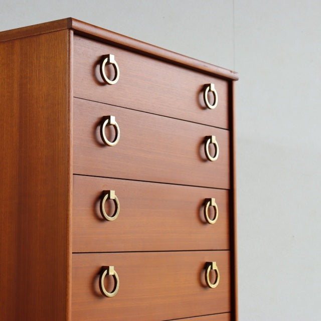 Mid-century vintage teak chest by Austinsuite with four drawers and brass ring handles, British design with smooth wood.