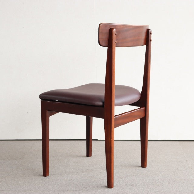 Vintage mid-century British teak dining chair by YOUNGER with rich wood grain, slender legs, and dark leather seat.