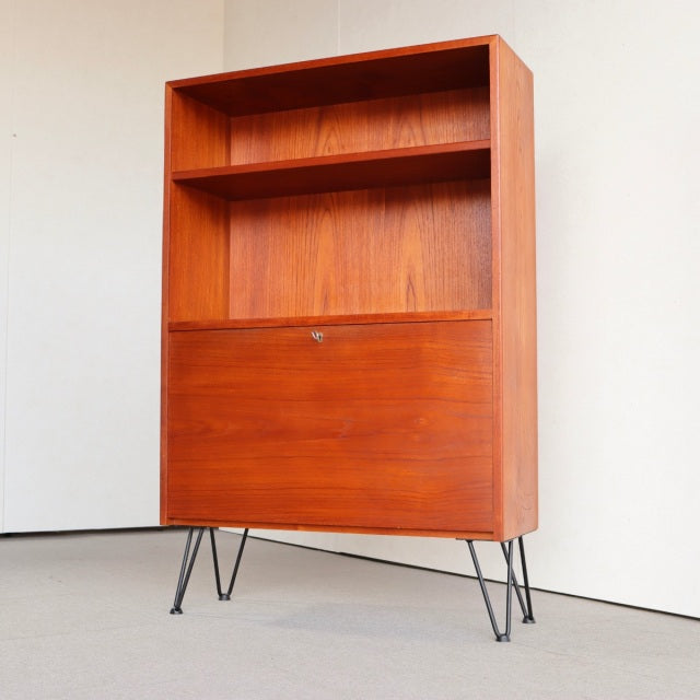 Mid-century vintage teak cabinet from Denmark with British iron hairpin legs, open shelves, and a drop-front door showcasing .