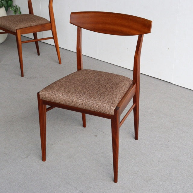 Vintage McIntosh teak dining chair with mid-century British design, curved backrest, and tapered legs upholstered in.