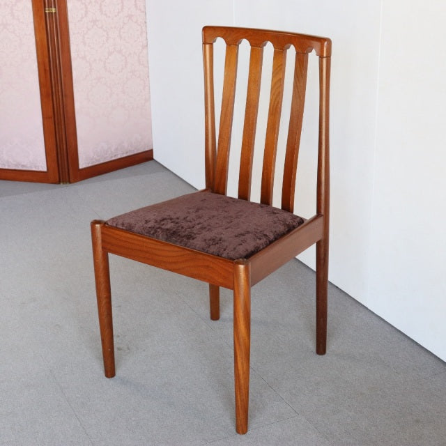 Mid-century British Meredew teak dining chair with vertical slat back and brown cushioned seat, showcasing rich wood grain.