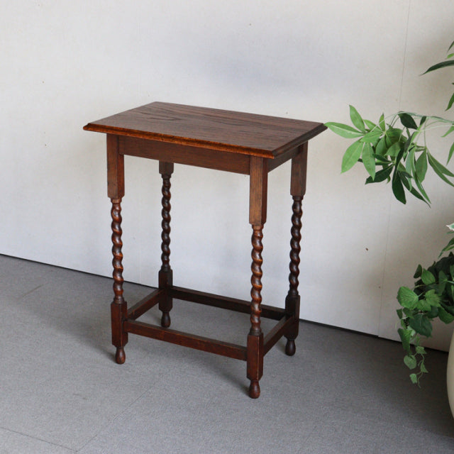 Vintage teak British side table with rich wood grain, twisted mid-century legs, and sturdy stretcher frame.