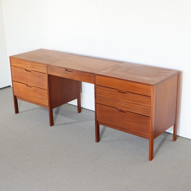 Mid-century British Fyne Ladye teak sideboard with rich wood grain, six drawers, and slender tapered legs.