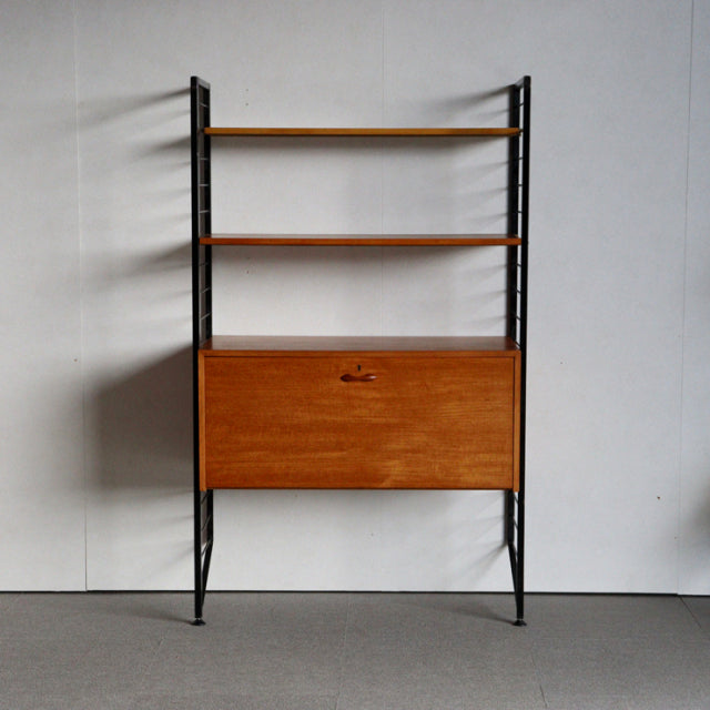 Vintage British Ladderax unit shelf with teak shelves and cabinet, mid-century black metal frame, clean wood grain, slender.