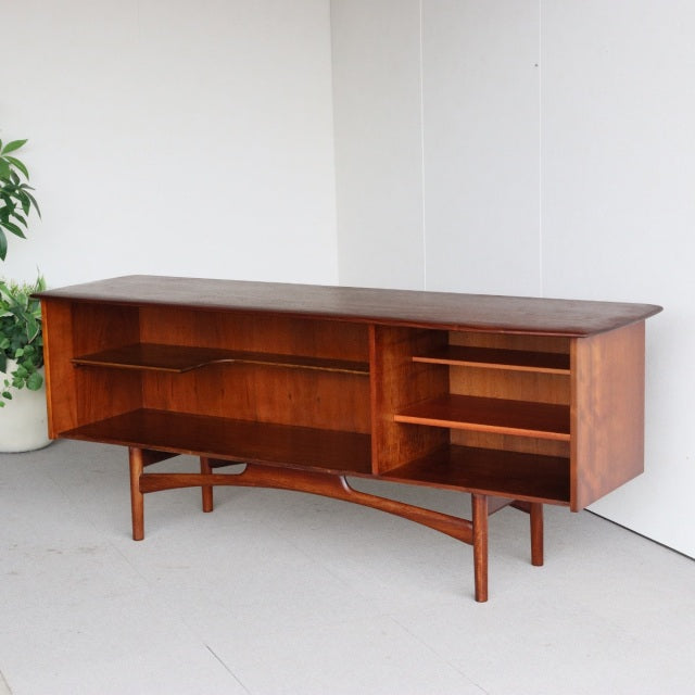 Mid-century British vintage teak sideboard by Dalescraft with rich wood grain, open shelving, and tapered legs from Denmark.
