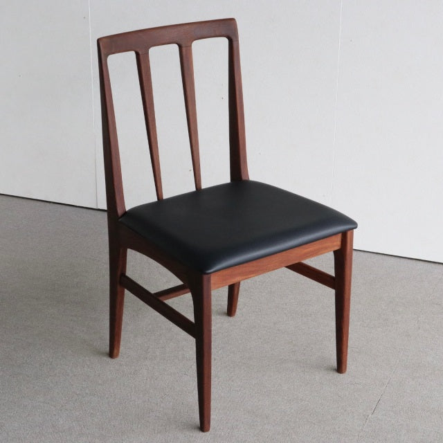Vintage mid-century British teak dining chair from Younger Fonseca series with black leatherette seat and sleek tapered legs.