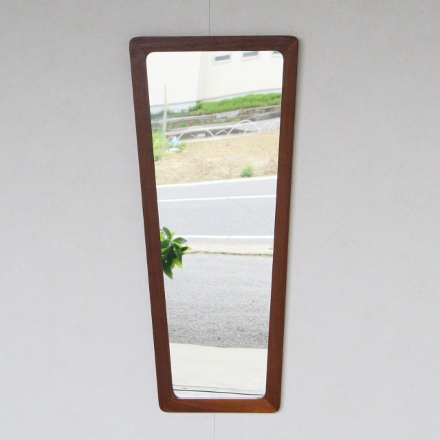 Vintage British mid-century teak trapezoid wall mirror with sleek wood grain frame, Scandinavian Denmark design influences.