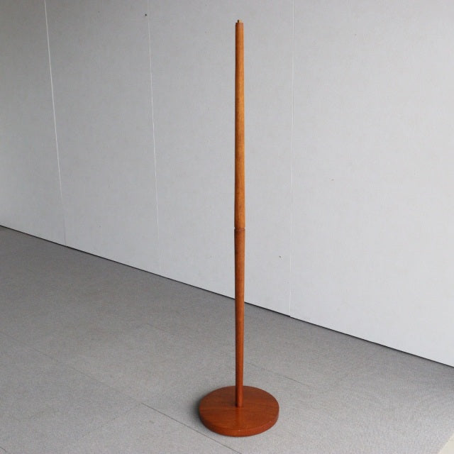 Vintage teak British mid-century floor lamp with slim tapered pole and round base.