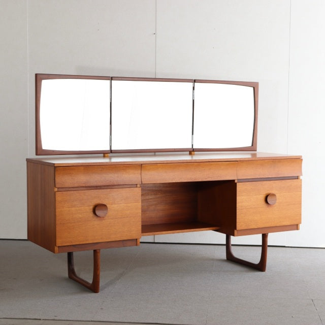 Vintage teak dresser with three rectangular mirrors, British mid-century design from Denmark, featuring clean lines and.