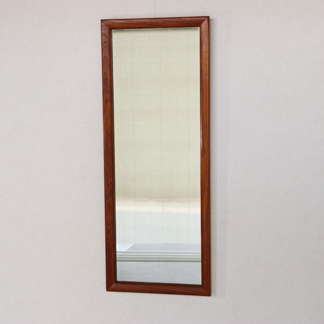 Vintage mid-century British teak rectangular wall mirror with sleek wooden frame and visible grain.